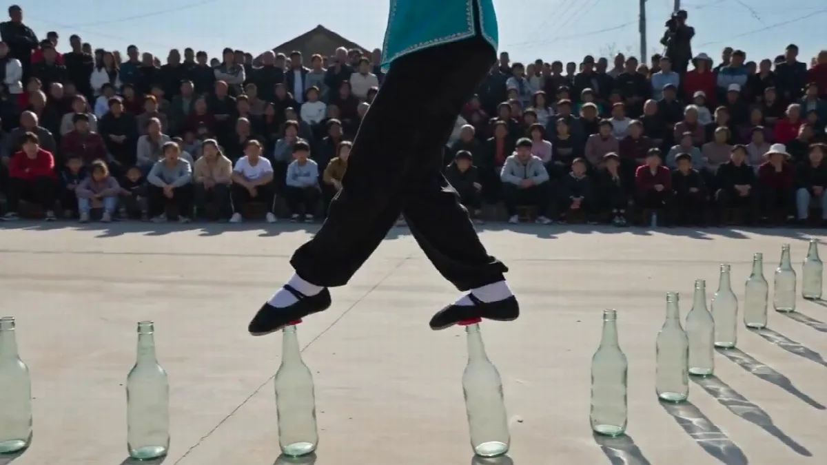 Acrobat Walking on Glass Bottles